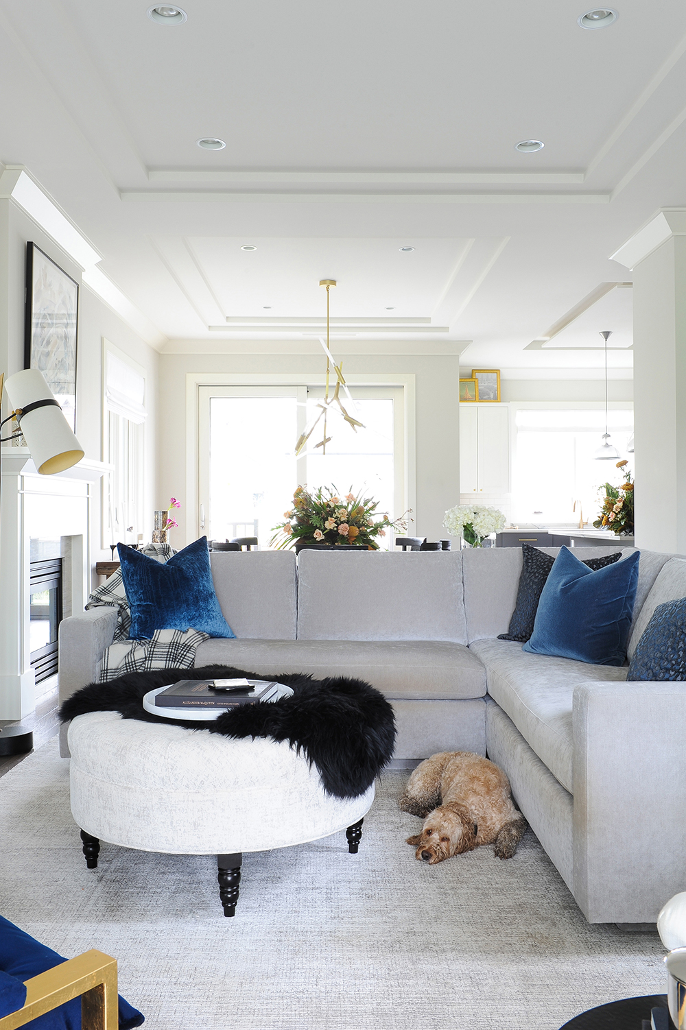 Stylish grey living room with hits of royal blue and brass.