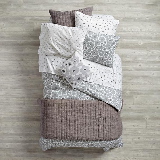 bed with grey bedding in a mix of patterns