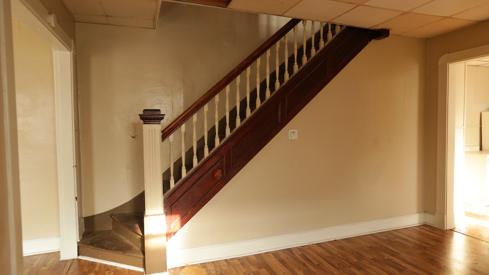 before of wooden staircase in beige room