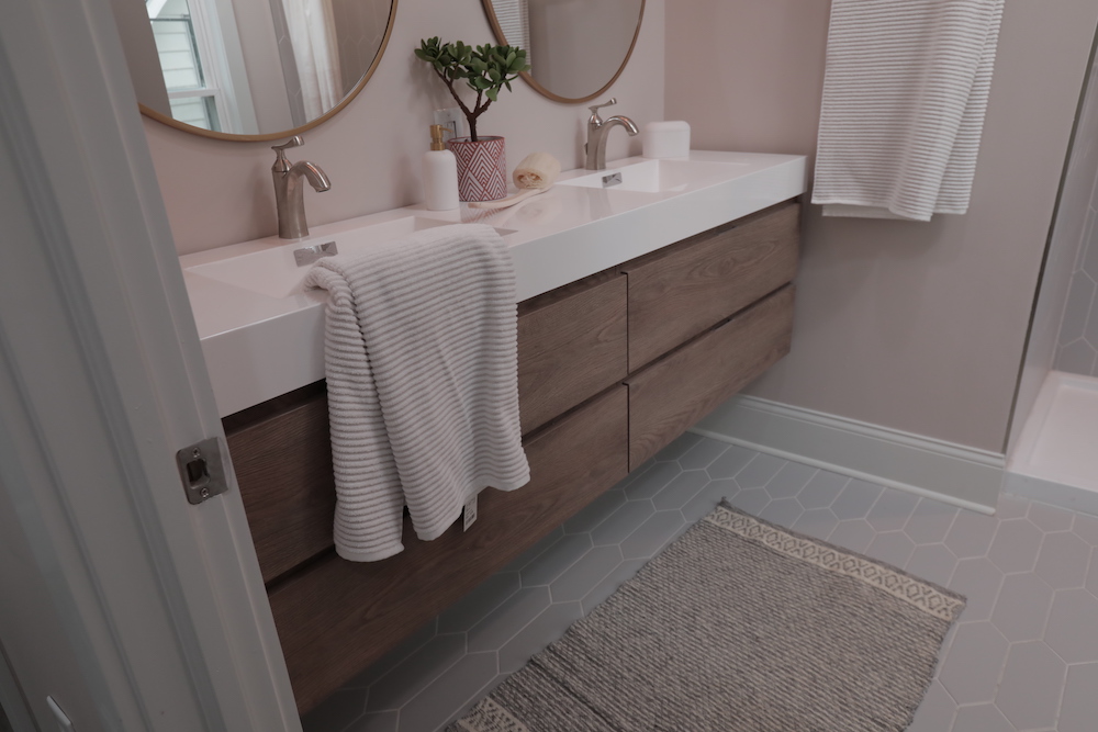 modern pink bathroom with dual vanity and grey tiled floor