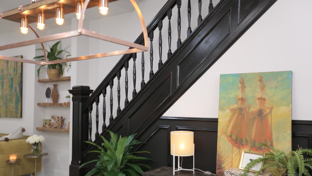 black-painted staircase in white open-concept living room