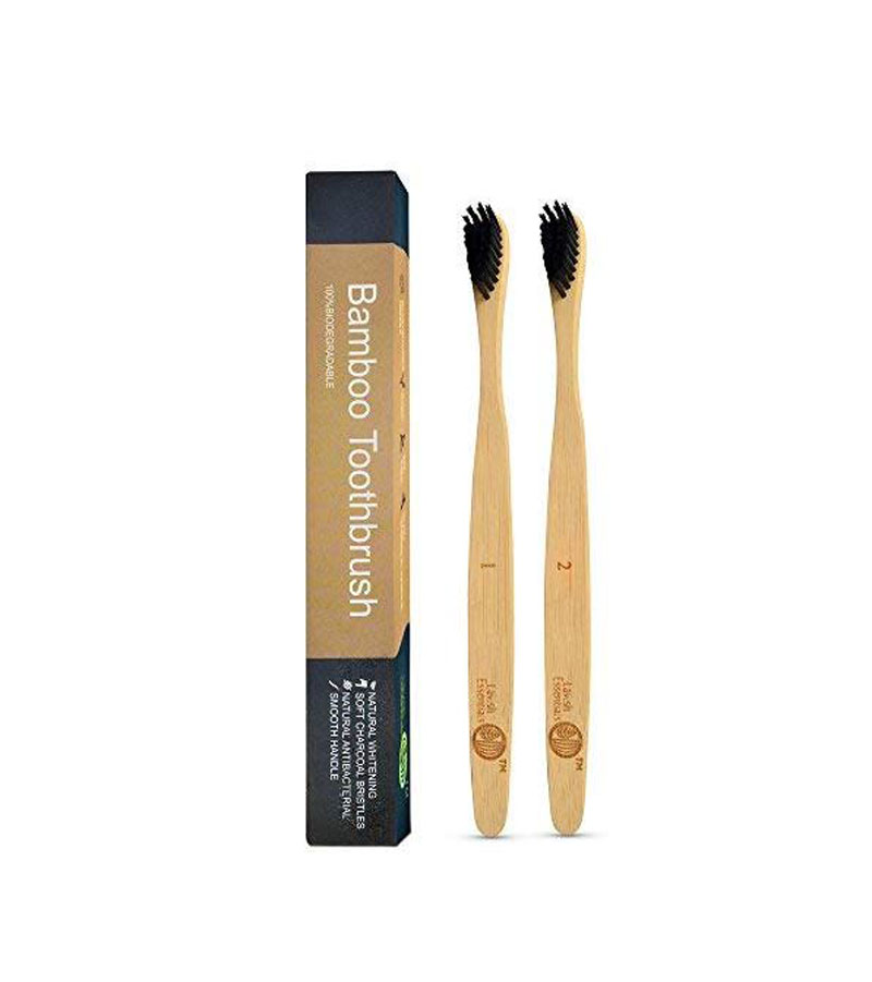 Two bamboo toothbrushes with a product case