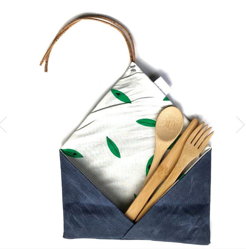 A reusable, biodegradable cutlery set in a patterned cloth envelope
