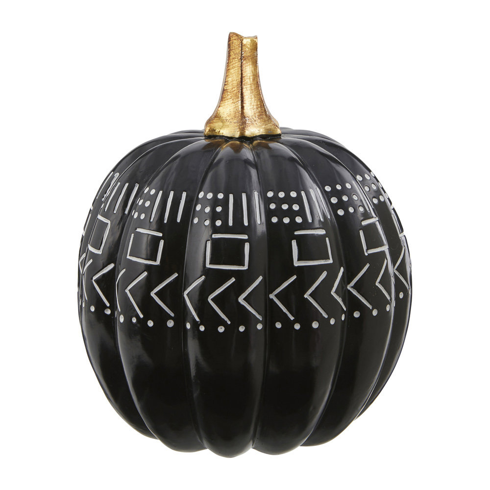 A black and white decorative pumpkin with gold accents