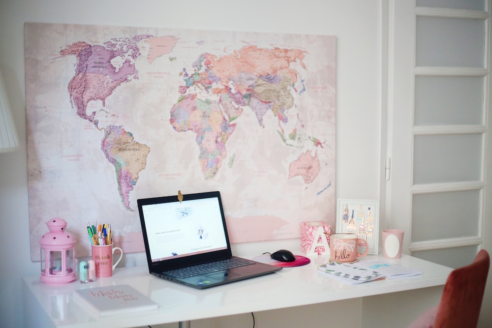 pink and purple map on white wall at desk