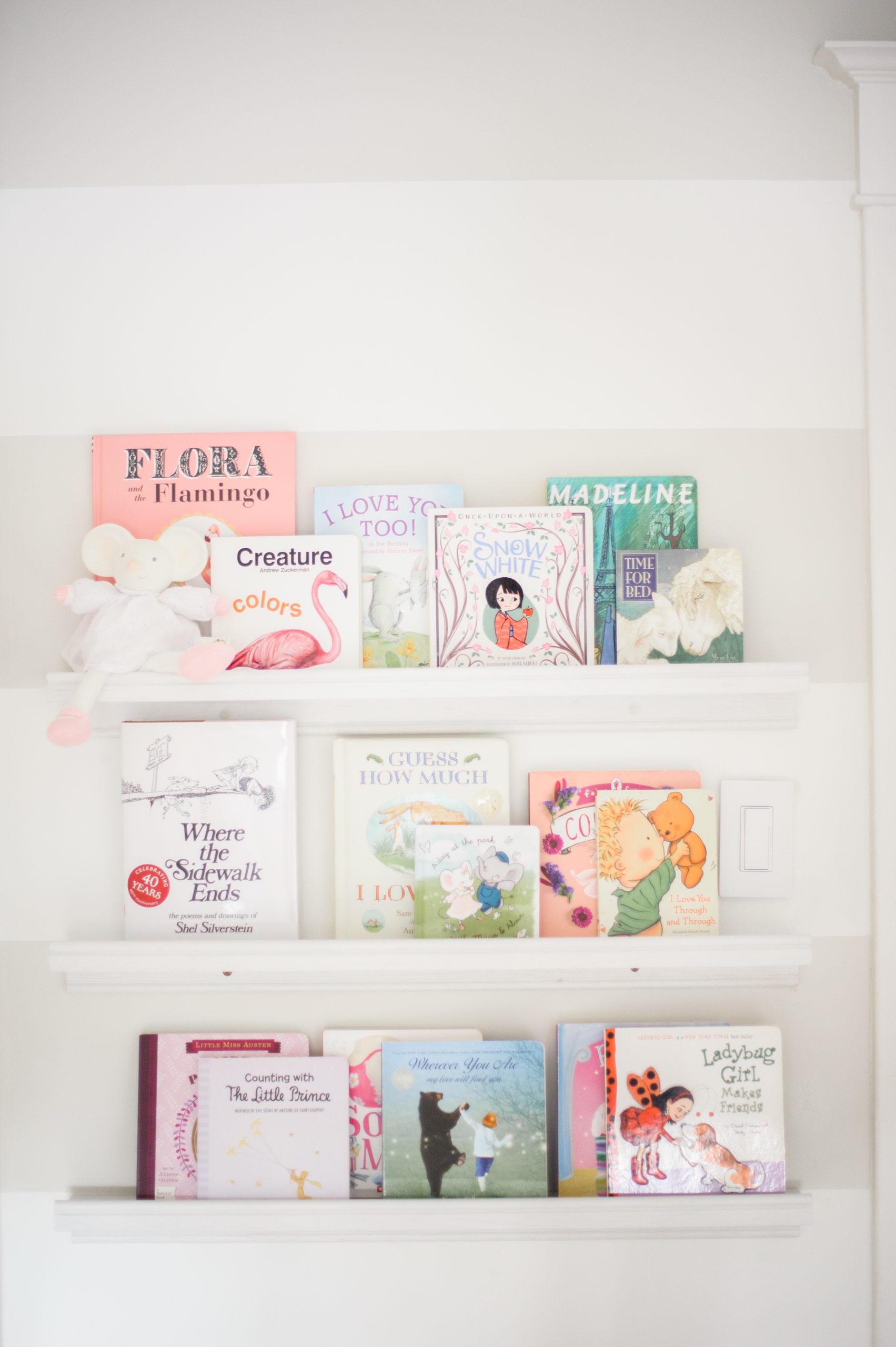 Picture ledges create a library wall to display children's books.
