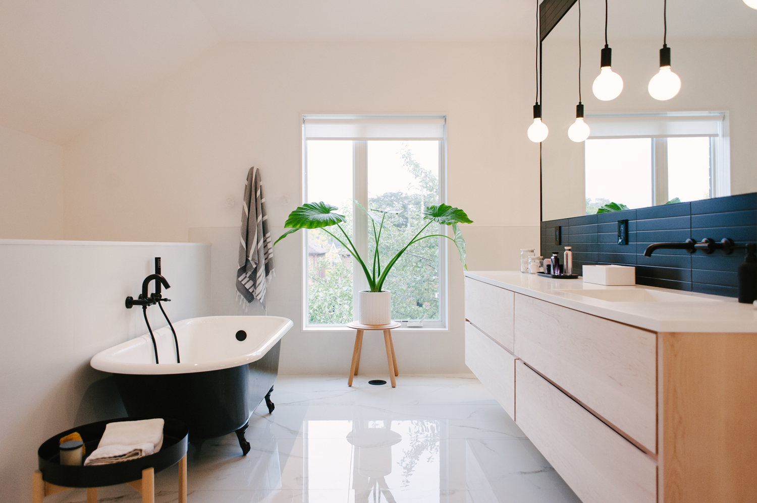 Sleek modern bathroom with black free-standing tub