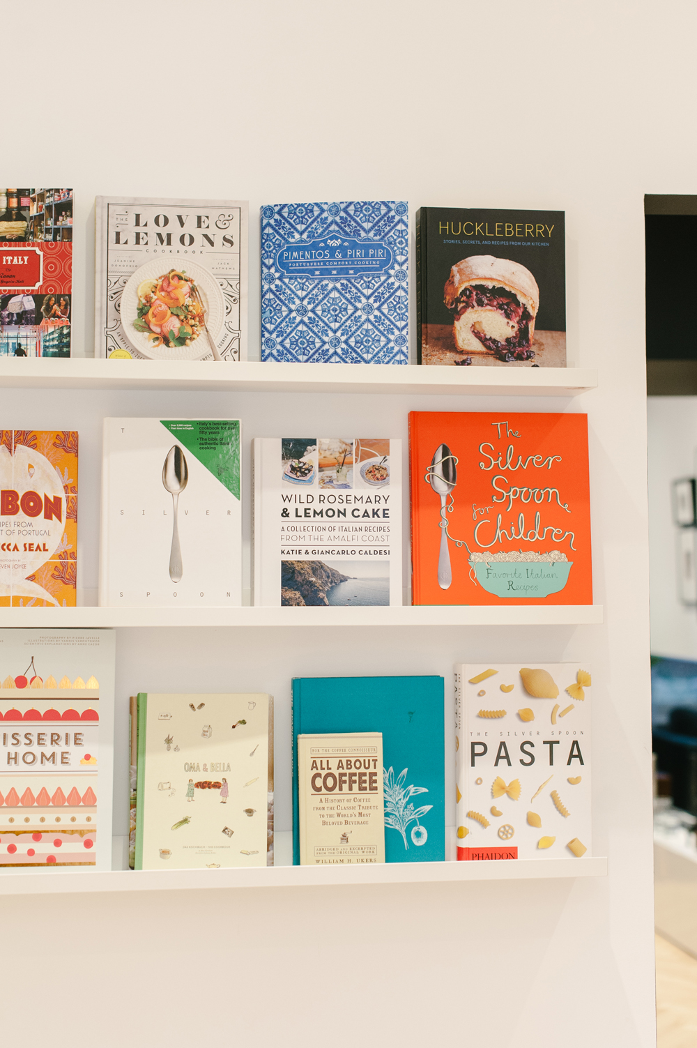 Cookbooks on display on floating white shelves