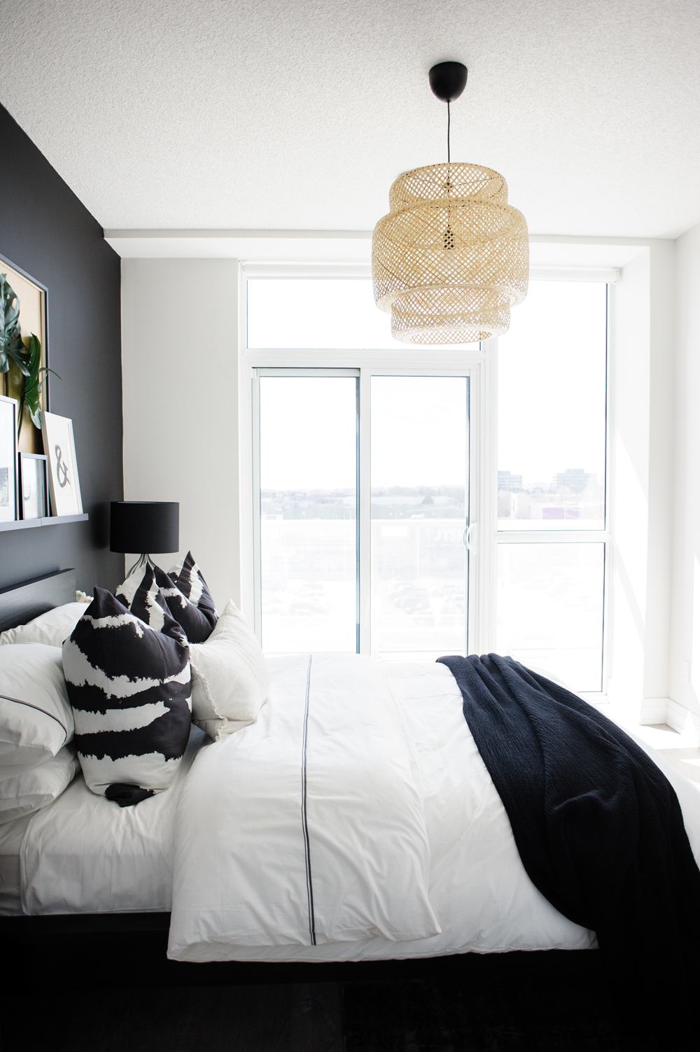White bedding with black and white pillows and throws