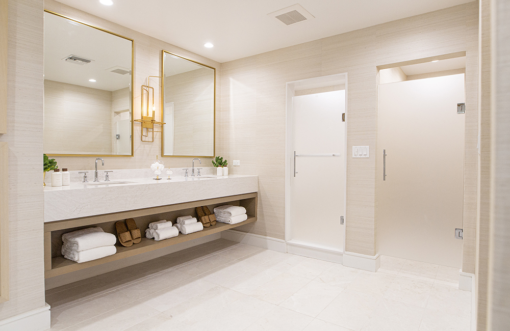 An oversized bathroom with a separate alcove for a water closet and a large shower area