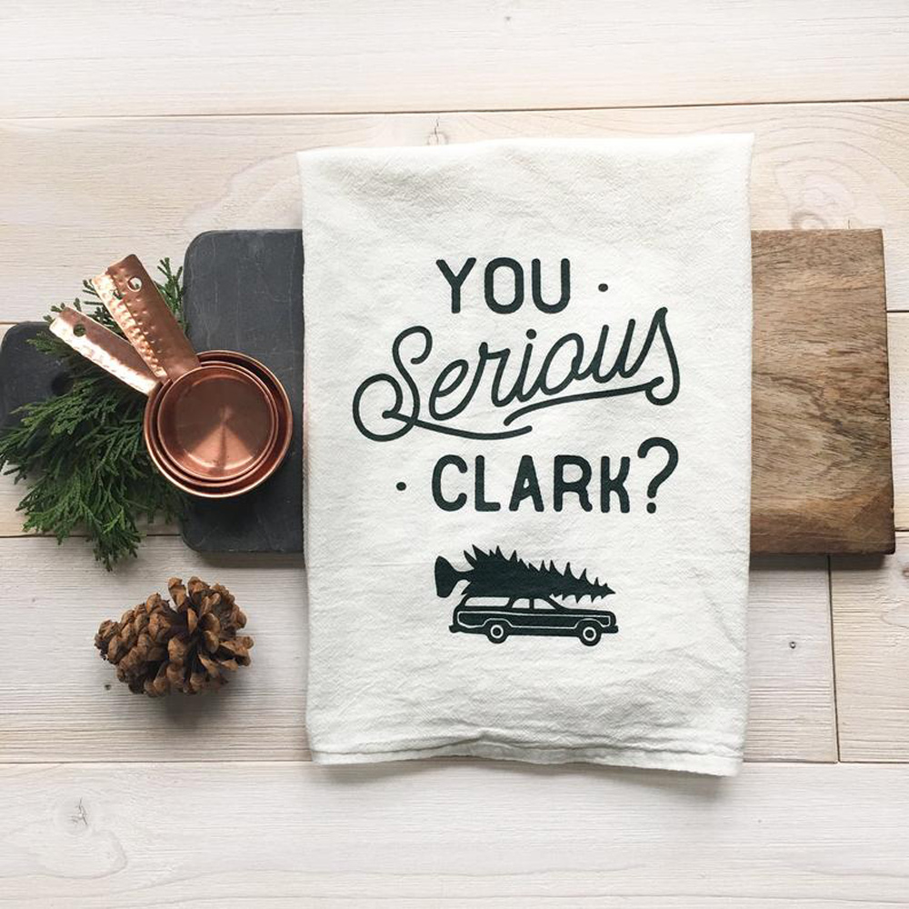 A handmade kitchen towel with a stitched quote from National Lampoon's Christmas Vacation
