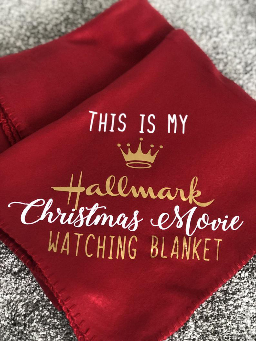 A red and gold Hallmark Christmas movie watching blanket