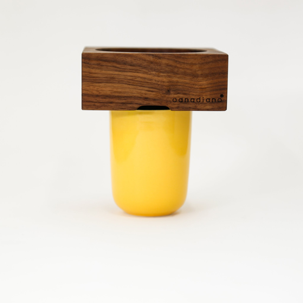 A yellow mug with a wooden pour-over for a morning cup of coffee
