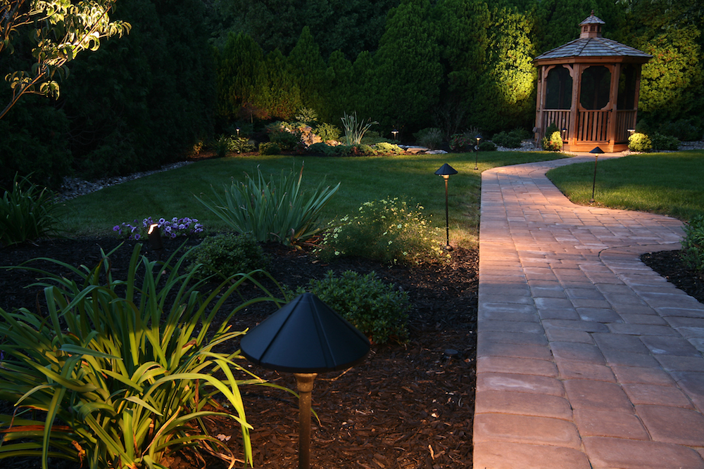 backyard garden with lighted path at night