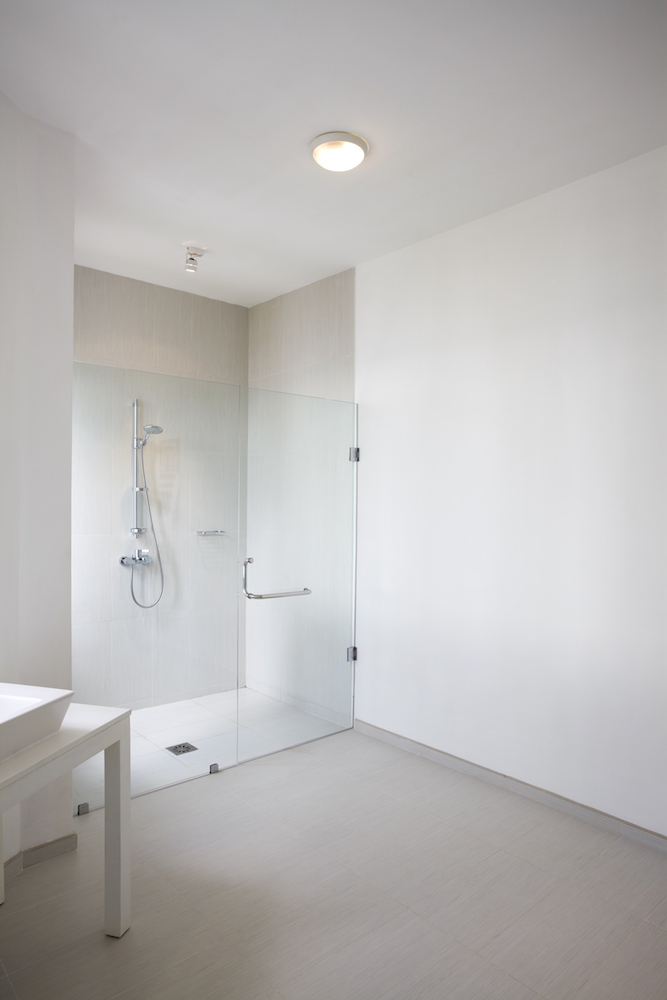 white background with a shower with a glass door