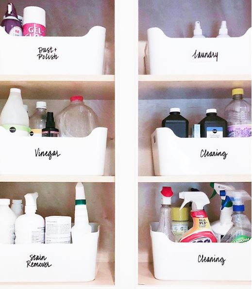 Clearly labelled white baskets in an organized laundry room