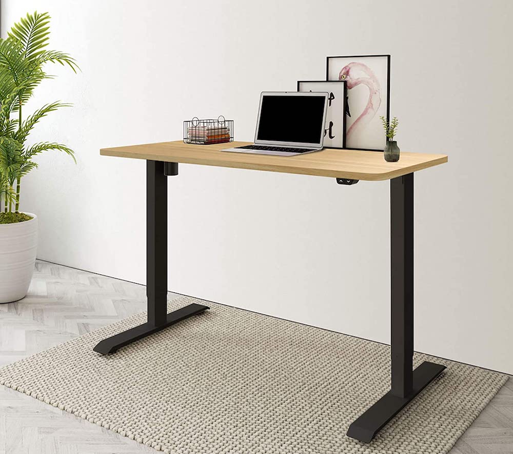 wood-and-black standing desk in clean home office