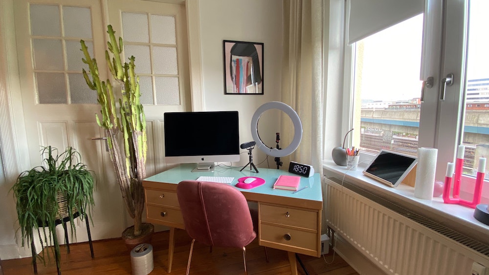 playful home office with pink accents and ring light on desk