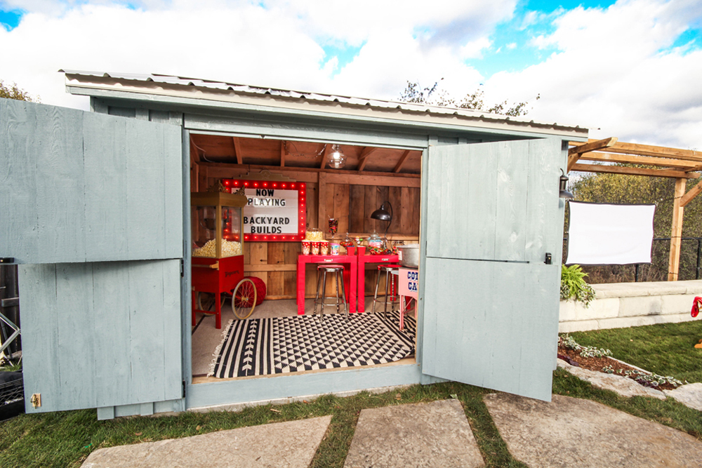 A backyard shed transformed into a snack stand for outdoor movie nights