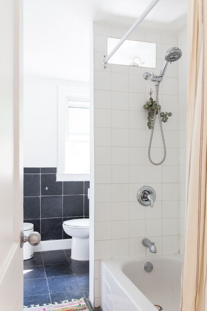 white bathroom with eucalyptuss hanging in shower