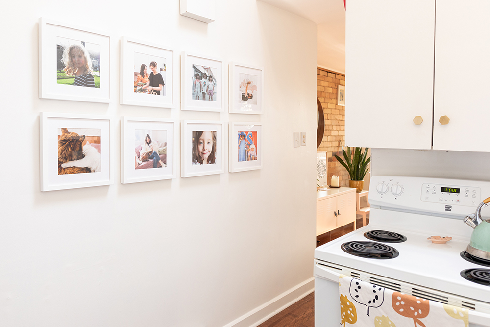 White kitchen with gallery wall of family photos