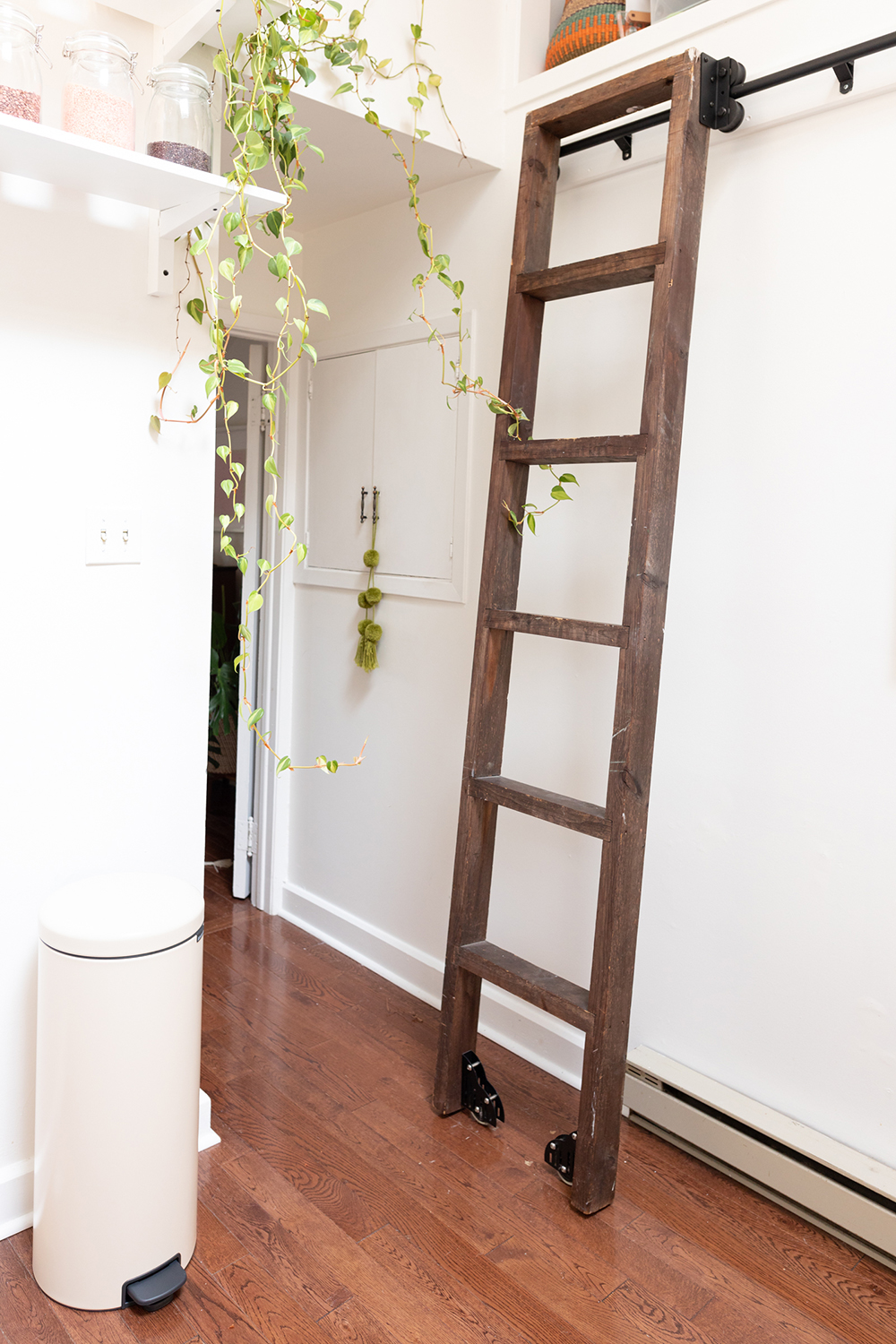 White kitchen with rolling wood ladder