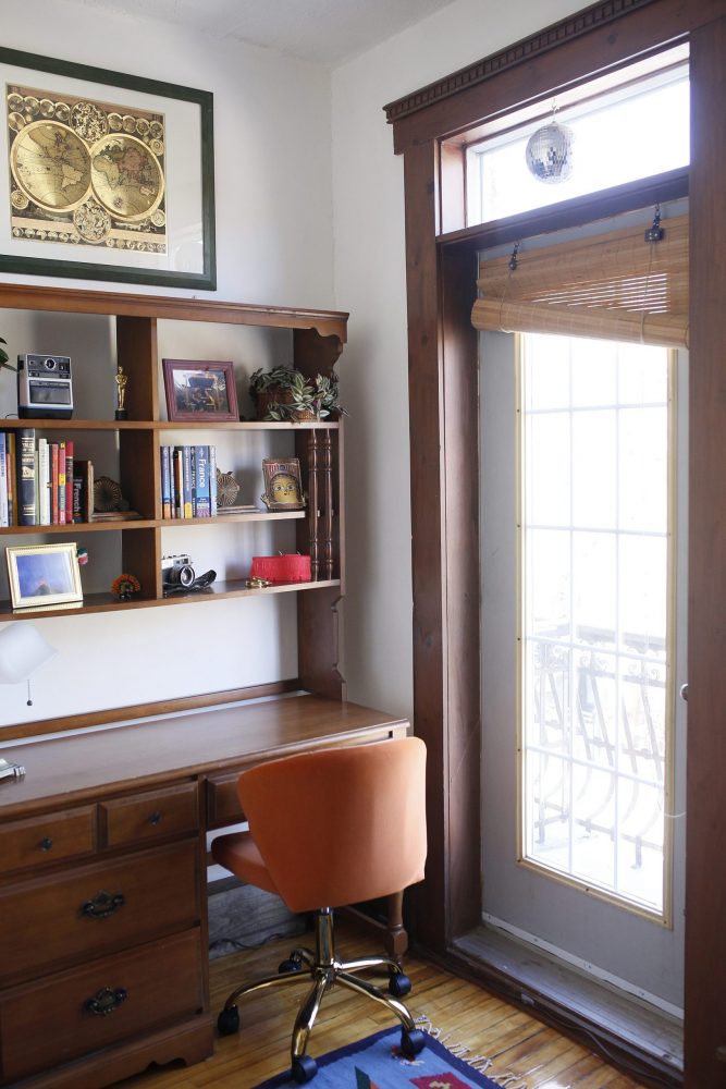 office nook with wooden desk and shelved and orange chair