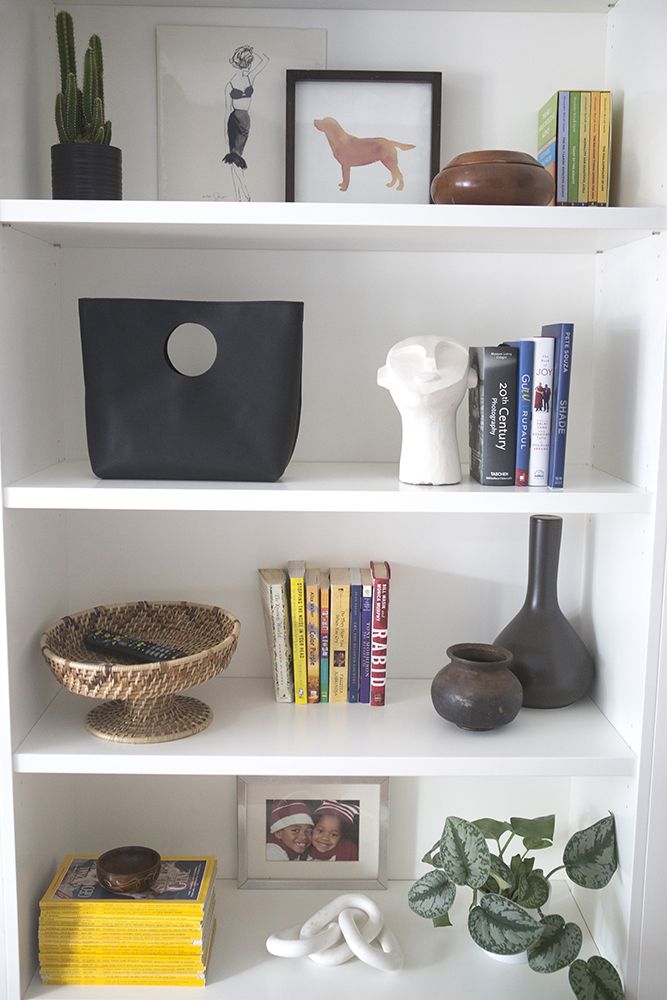 White shelves filled with books, magazine and photos