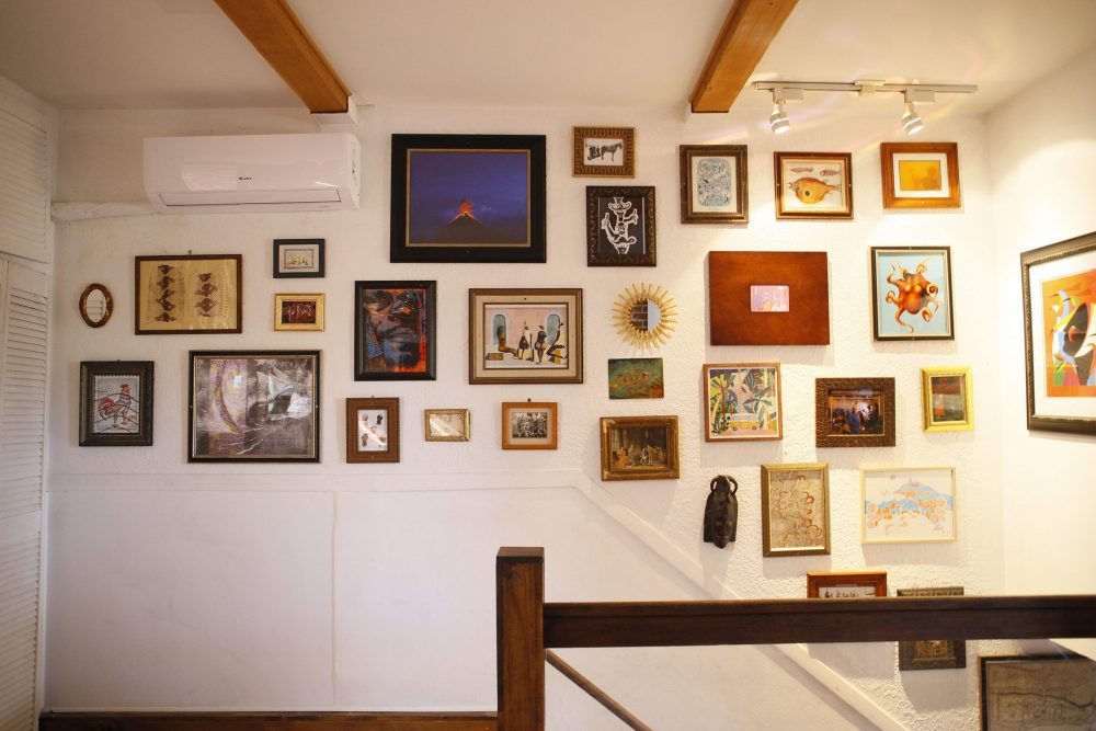living room with top of stairs and gallery wall of images