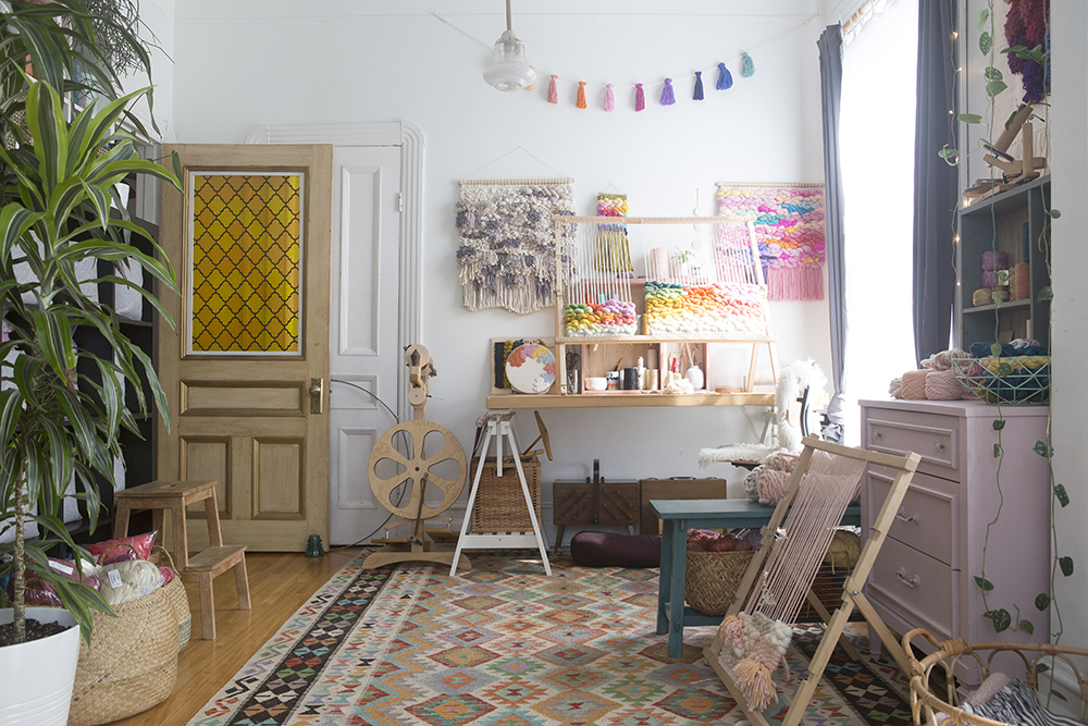 Brightly coloured studio space with in-progress macrame items