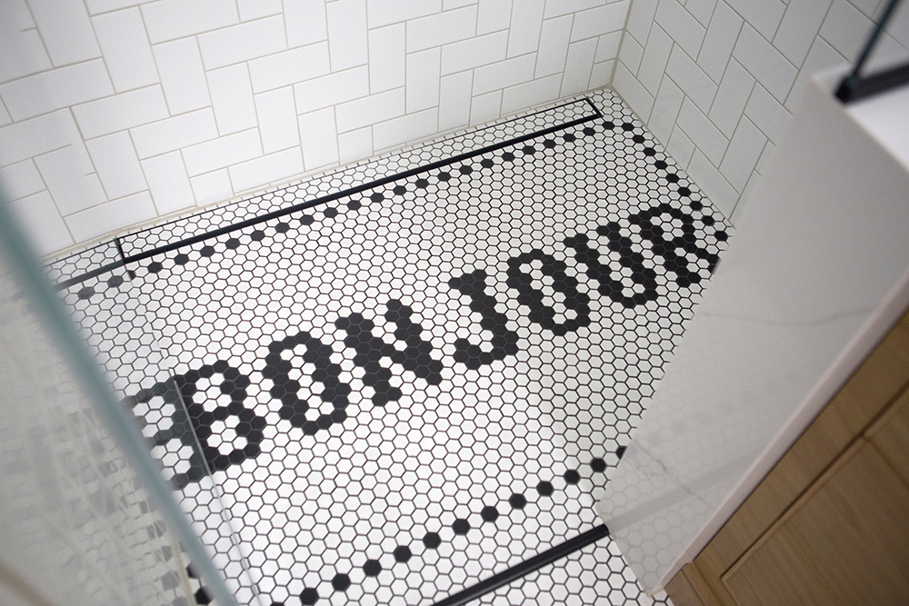 Bathroom floor tiled with the word 