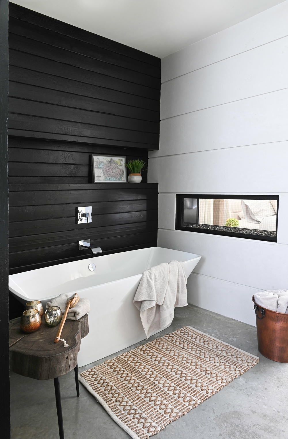 white vessel tub, black wall, rectangular black framed window