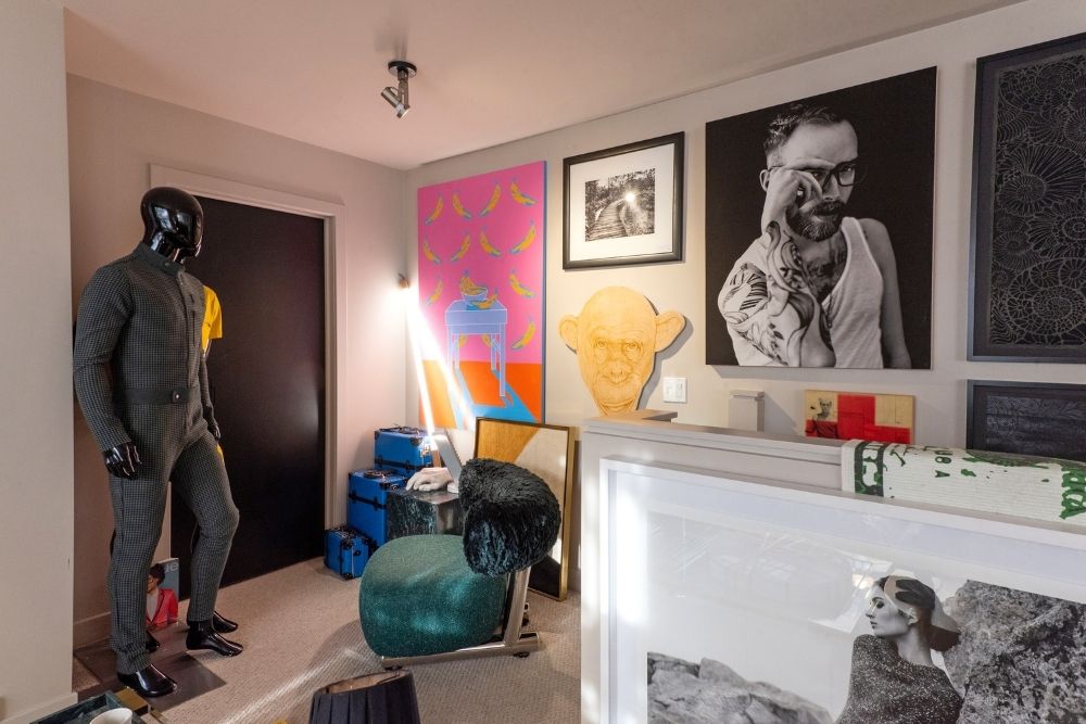 corner of bedroom, art wall, mannequin wearing one piece suit