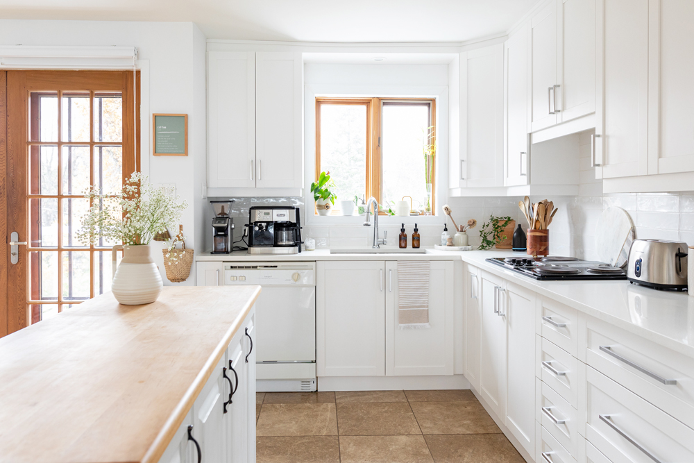 white kitchen with white appliances and centre island