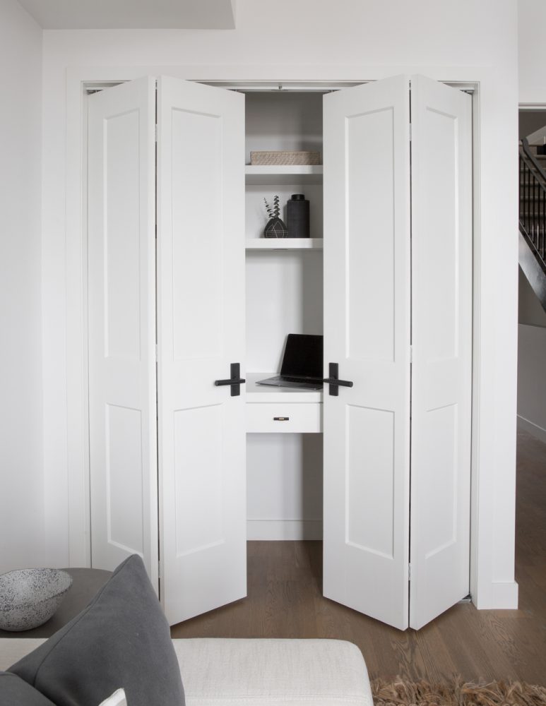 white closet doors opening to reveal a hidden desk