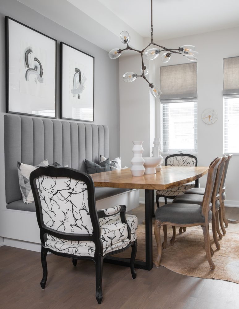 modern grey dining room with banquette bench and assorted chairs