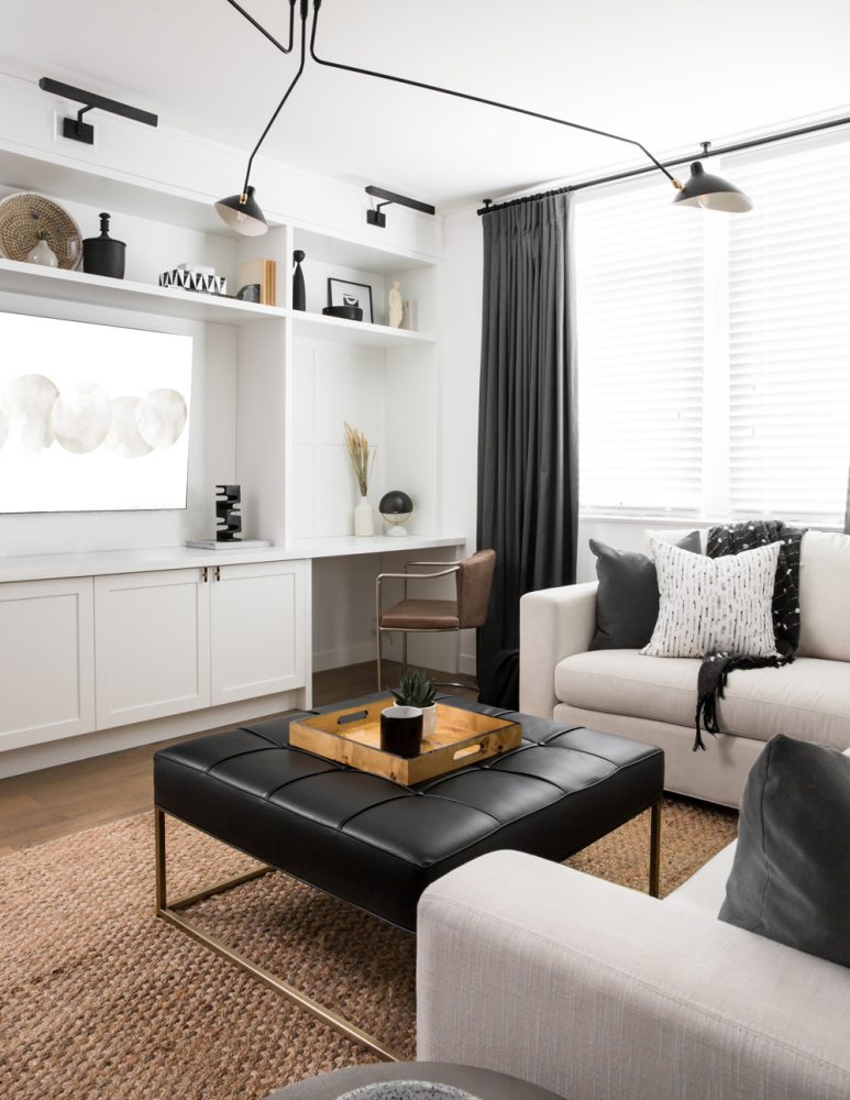 white family room with built-in shelving and desk area