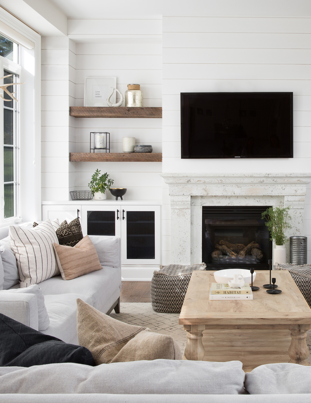 tv over fireplace, two wood floating shelves, 