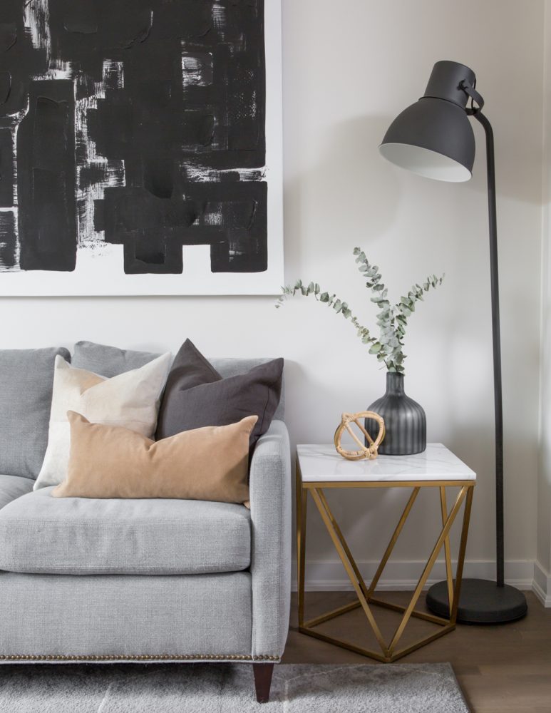 grey living room with side table and black lamp