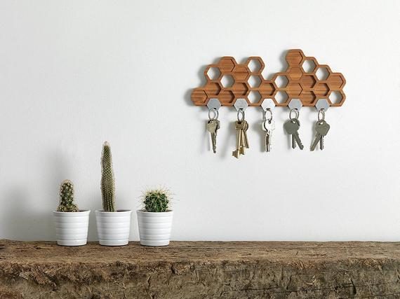 Brown honeycomb-shaped wall hook with keys dangling from the holders