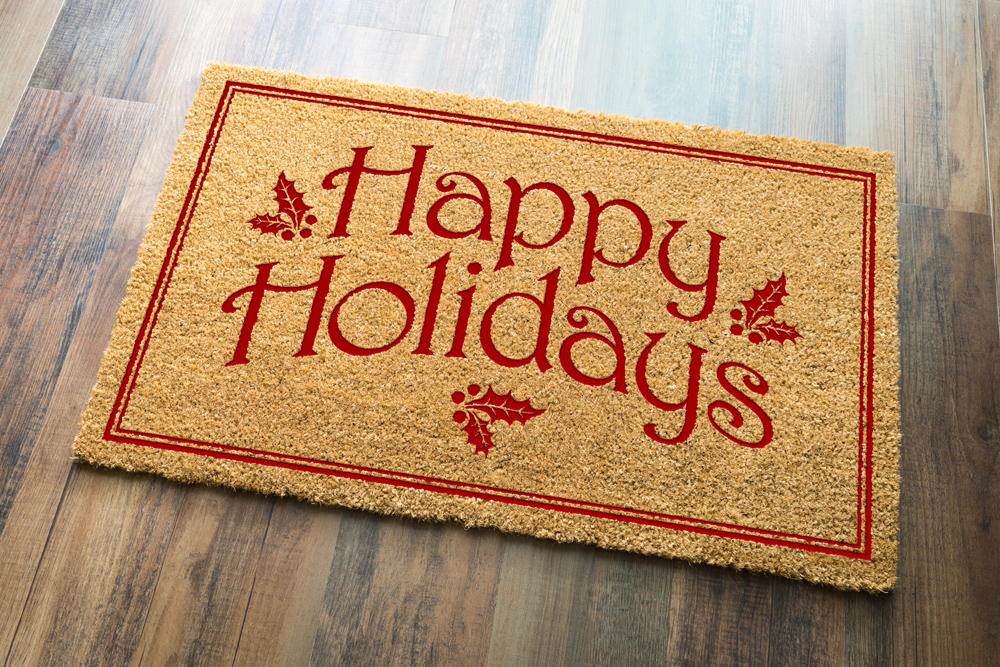 A red holiday-themed doormat