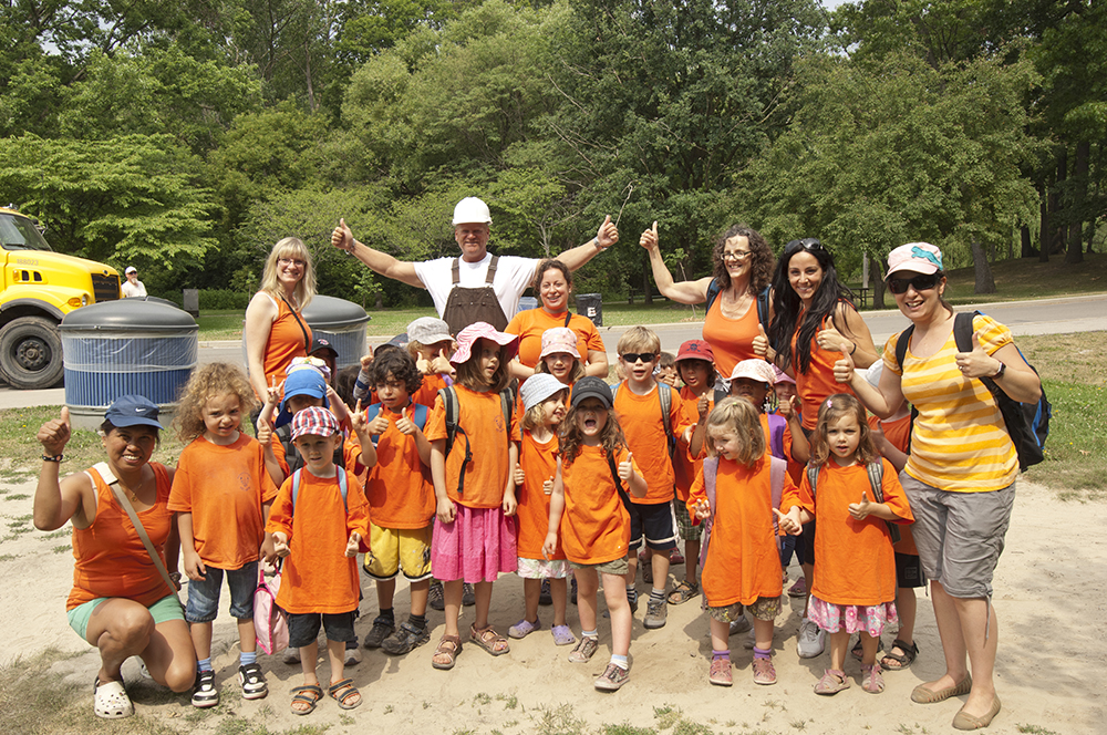 Mike Holmes standing with a group of kids at a local summer camp