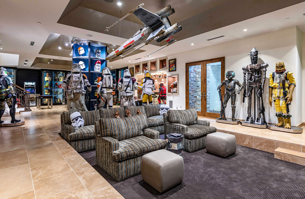 Comfy chairs and couch in the basement screening area surrounded by Star Wars memorabilia