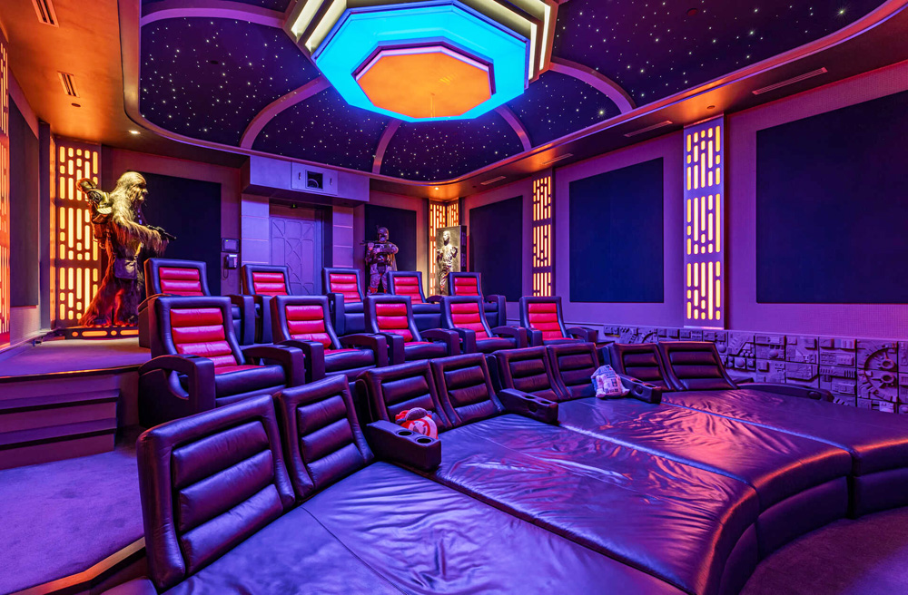 The basement screening room with Star Wars memorabilia and reclining chairs and chair-beds