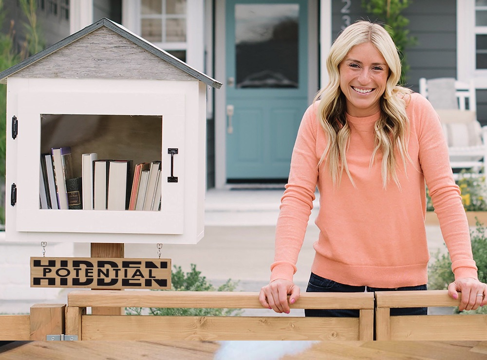Jasmine Roth of Hidden Potential smiling with a book library.