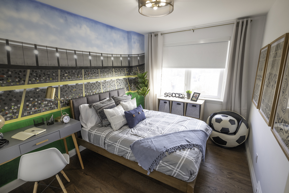 kids bedroom with sports-themed mural on wall