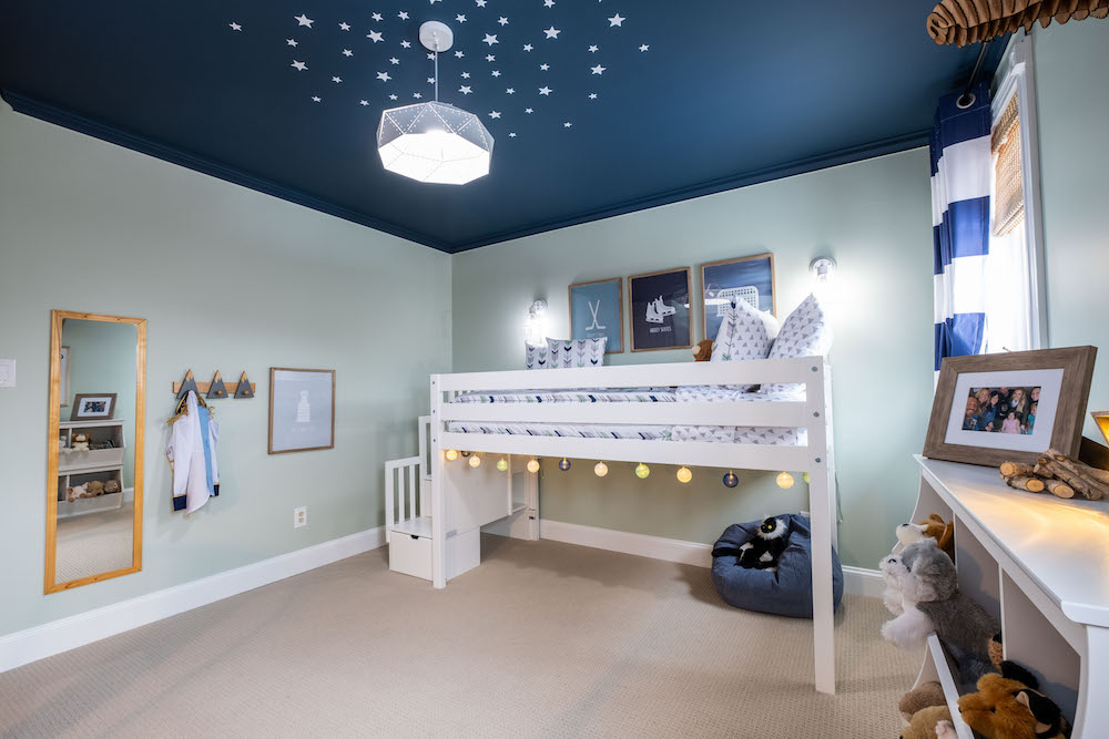 blue-and-green kids' room with white loft bed and white stars painted on the ceiling