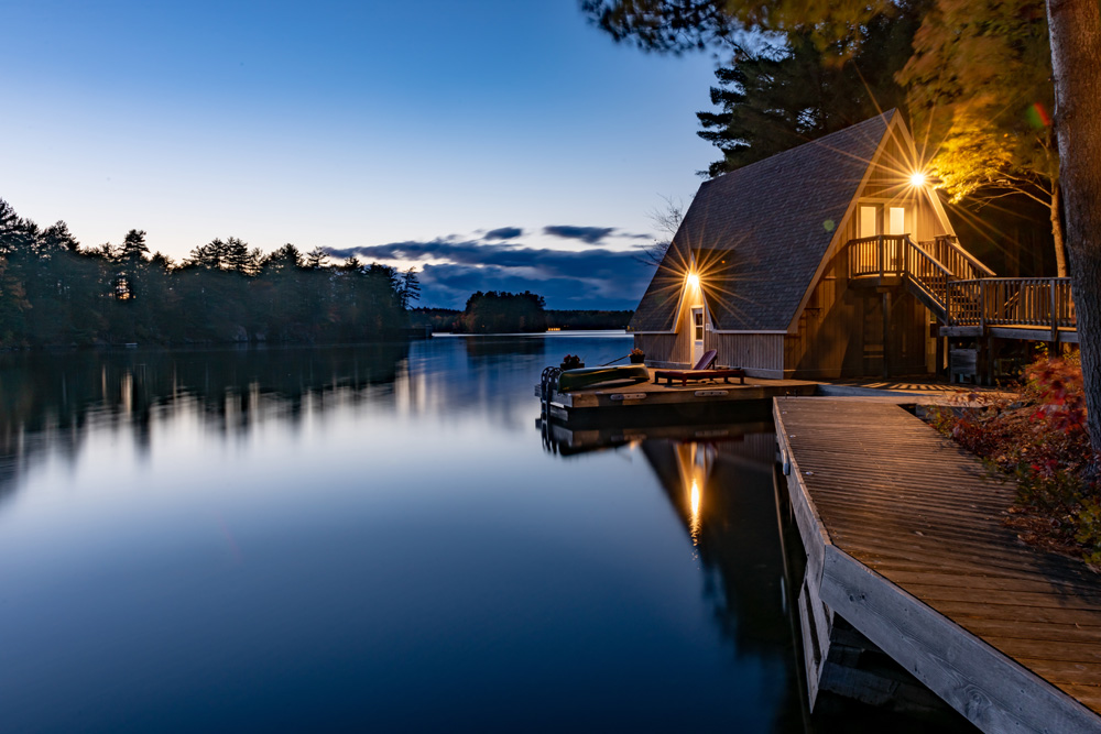 Cottage on a lake at dusk