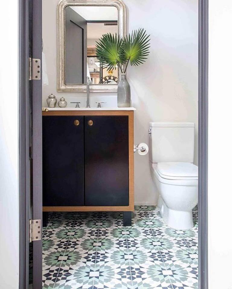 Tropical-inspired bathroom with encaustic floor tiles.