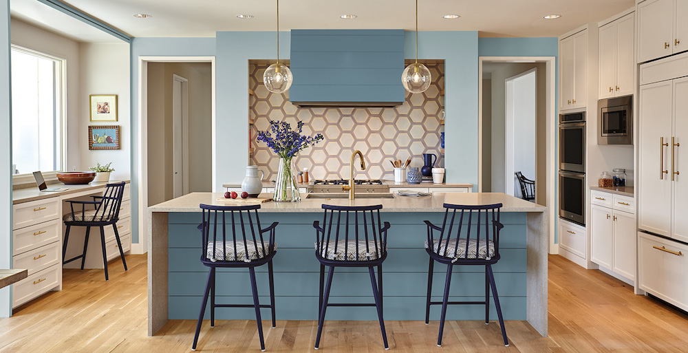 modern kitchen with blue walls, blue cabinets and a geometric backsplash